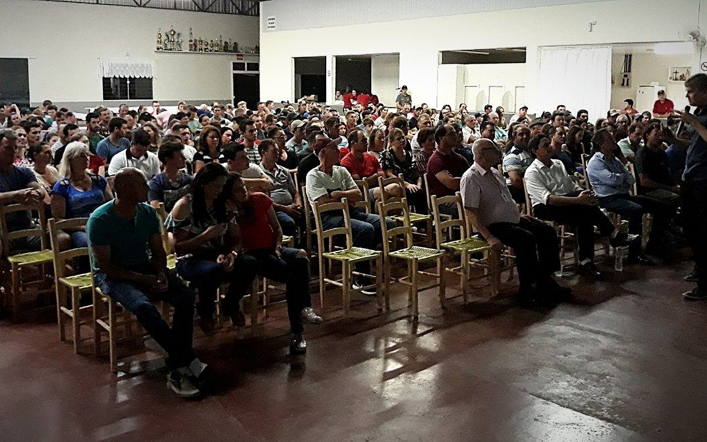 A full community hall during a talk in the countryside